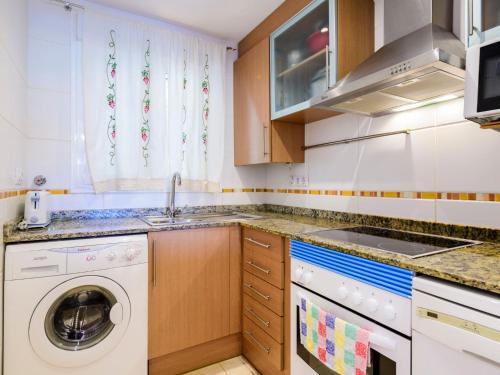 a kitchen with a washer and a washing machine at Apartment Blue by Interhome in Oropesa del Mar