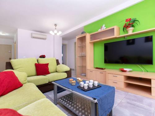 a living room with a couch and a tv at Apartment Ancora by Interhome in Platja d'Aro