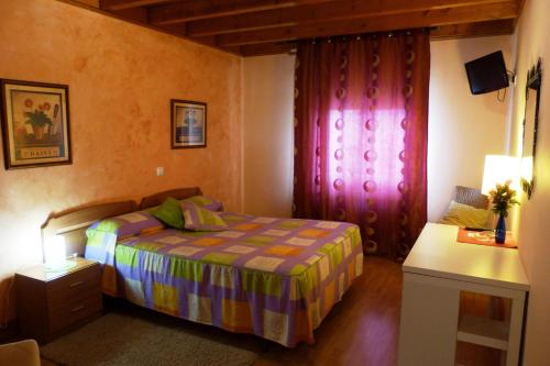 A bed or beds in a room at Hotel El Golobar