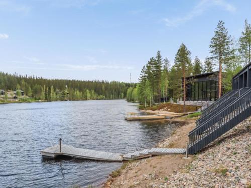 a river with two boats in the water at Holiday Home Lakevillas b1 price includes 4 ski passe by Interhome in Hyrynsalmi