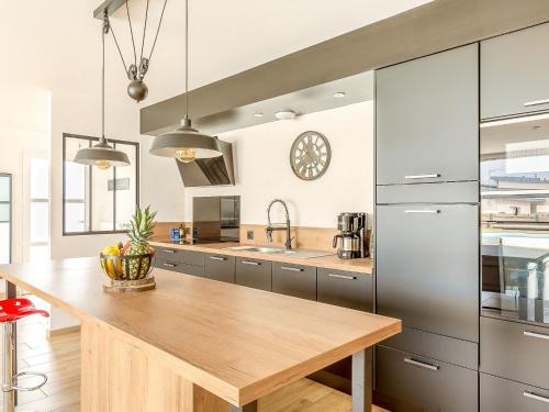 a kitchen with a wooden counter top in a room at Holiday Home Les Lagons du Lividic by Interhome in Plounéour-Trez