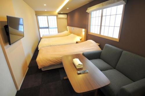 a small room with two beds and a couch at HIZ HOTEL Kyoto Nijo Castle - Vacation STAY 12567v in Kyoto