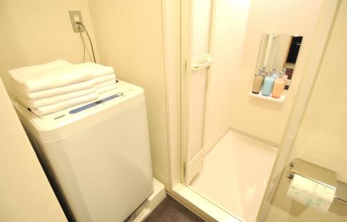 a bathroom with a shower and a toilet with towels at HIZ HOTEL Kyoto Nijo Castle - Vacation STAY 12551v in Kyoto