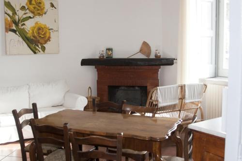 a living room with a table and chairs and a fireplace at Palazzo D'Orsi in Calvanico