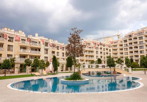 een groot gebouw met een groot zwembad ervoor bij Beautiful Apartments in a Luxury Residence in Varna in Varna