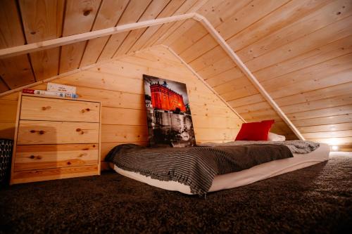 a bedroom with a bed in a wooden cabin at San_Domek in Sandomierz
