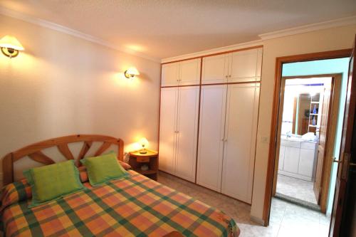 a bedroom with a bed and a door to a bathroom at Vivienda Oscar in Puerto Naos
