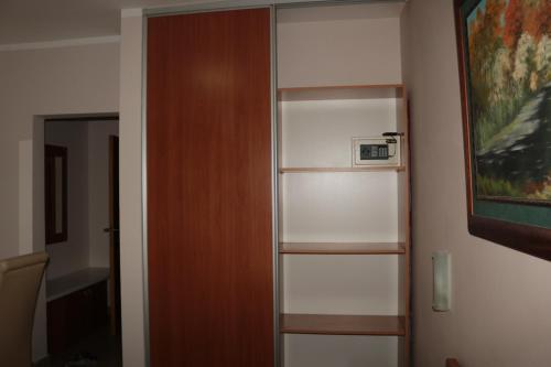 a book shelf in a room with a painting at Hotel Perjanik in Danilovgrad