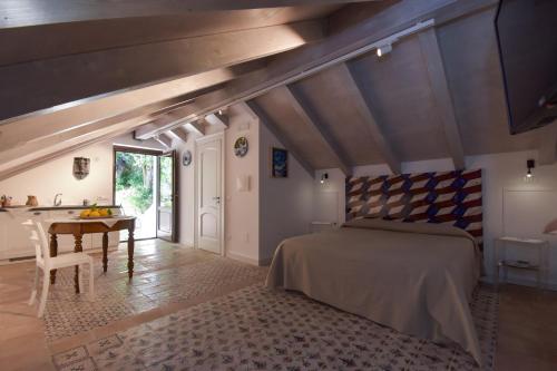 ein Schlafzimmer mit einem Bett und einem Tisch in einem Zimmer in der Unterkunft Bella Baia Relais in Maiori