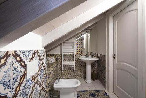 a bathroom with a sink and a toilet at Bella Baia Relais in Maiori