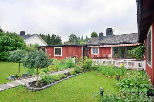 a garden in front of a red house at Private Room in Shared House-Close to University and Hospital-2 in Umeå