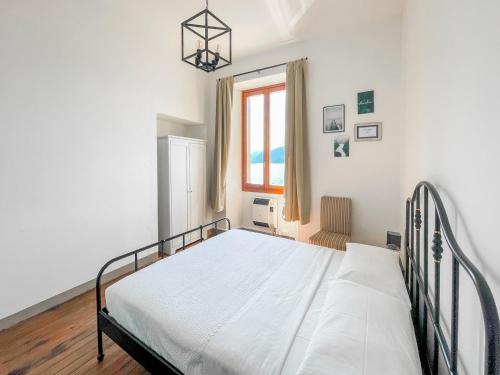 a bedroom with a bed and a window at MAGIC TERRACE by Design Studio in Varenna