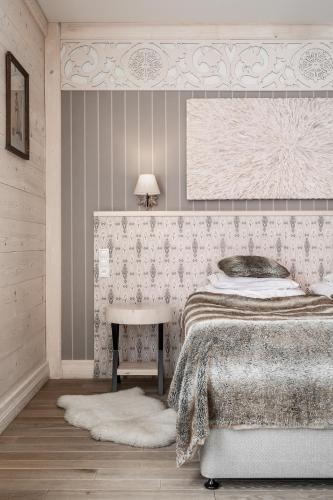 a bedroom with a bed and a sink and a table at Aries Hotel & SPA Zakopane in Zakopane