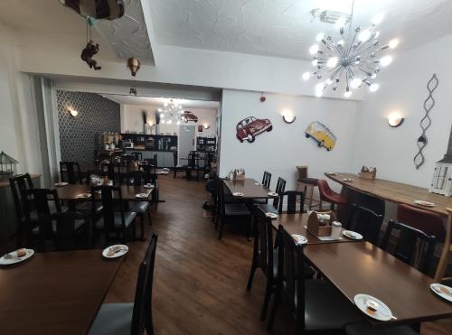 a dining room with wooden tables and chairs at Mardi Gras Hotel in Blackpool