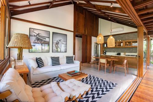 a living room with a couch and a table at Colibri Beach Villas in Ilha de Boipeba