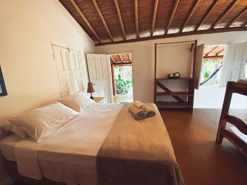 מיטה או מיטות בחדר ב-Vila Flor de Jambo