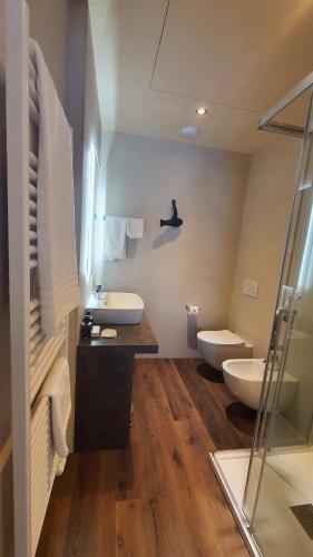 a bathroom with two toilets and a sink and a shower at ORIZZONTI Vigneti Repetto in Sarezzano