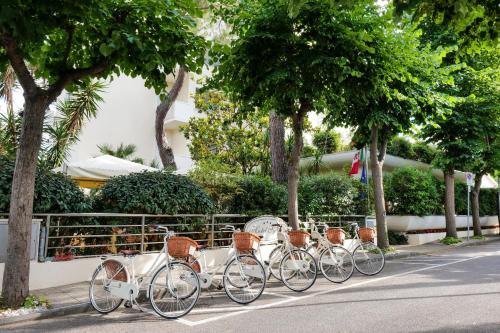 a row of bikes parked on the side of a street at Hotel Sylvia in Lido di Camaiore