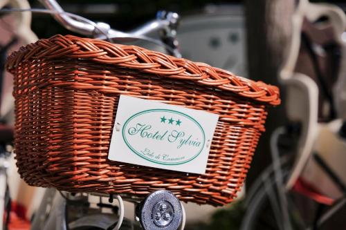 a basket on a bike with a sign on it at Hotel Sylvia in Lido di Camaiore