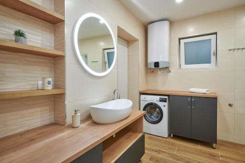 a bathroom with a sink and a washing machine at Newly renovated apt. near to entrance to Old Town in Dubrovnik