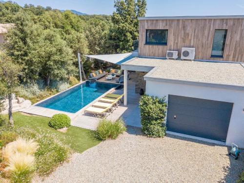 une maison avec une piscine à côté d'un bâtiment dans l'établissement Porto Vecchio Villa Bagatelle 8 personnes, à Porto-Vecchio