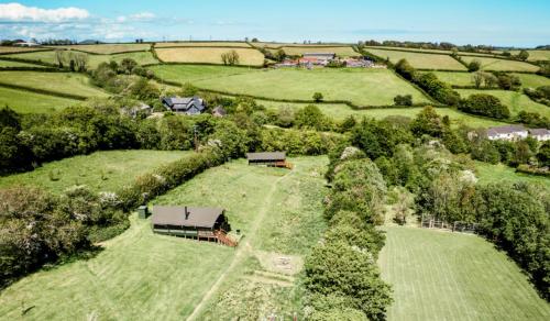 an aerial view of a house in the middle of a field at Brackenhill Glamping - Safari Tent with Hot Tub in Ivybridge