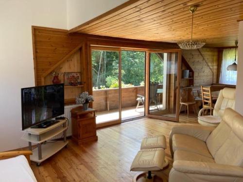 a living room with a couch and a flat screen tv at Apartments Blaschegg im Zentrum in Altmünster