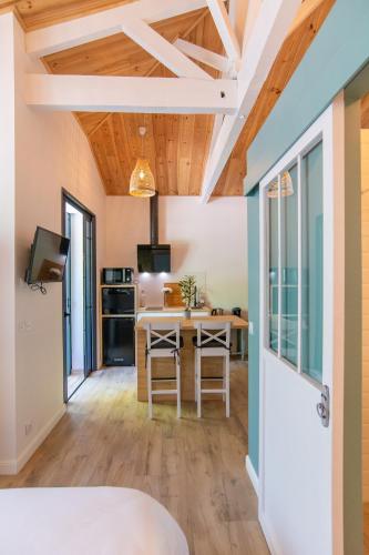 a kitchen and dining room with a table and chairs at Welcôm Apparts-chic et intimiste-100m du Port in La Teste-de-Buch