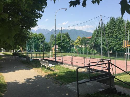 a tennis court with a bench on a tennis court at Da Tosca in Gravellona Toce