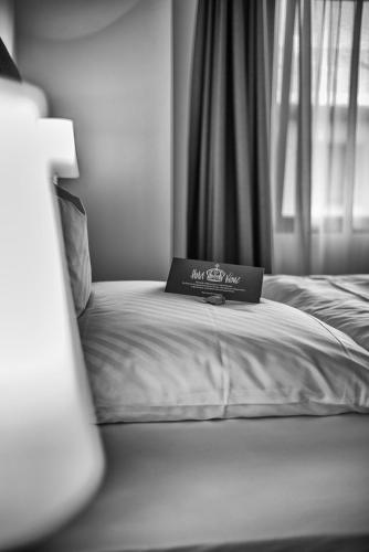 a bed with a laptop on it in a bedroom at Hotel Krone in Steinenbronn