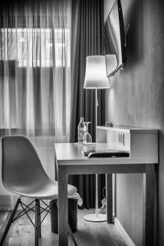 a desk with a chair and a lamp in a room at Hotel Krone in Steinenbronn