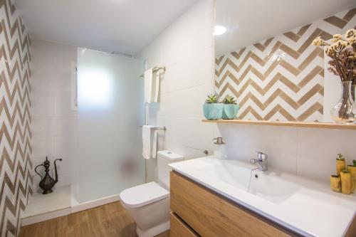 a bathroom with a sink and a toilet at Casara Tres - 2 Dormitorios - Jardín y acceso Privado a la Playa in Zahora