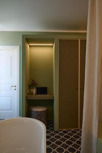 a room with a door and a desk with a laptop at Villa Marengo Guest House in Spinetta Marengo