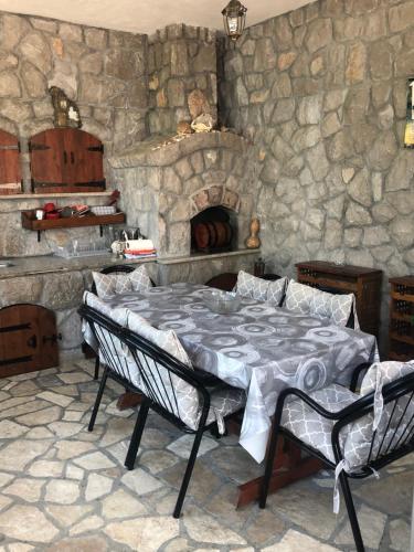 a stone room with a bed and a stone wall at Drakulovic apartmani in Herceg-Novi