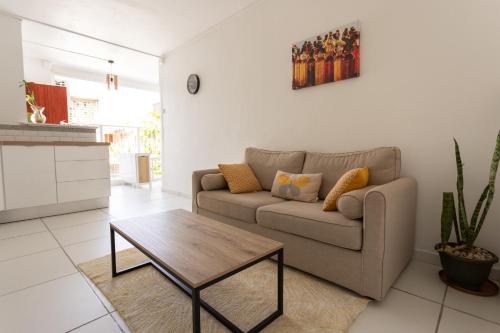 a living room with a couch and a coffee table at Place de la Cathédrale de Pointe à Pitre in Pointe-à-Pitre