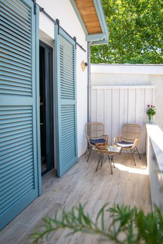 a patio with two chairs and a table at Welcôm Apparts-chic et intimiste-100m du Port in La Teste-de-Buch