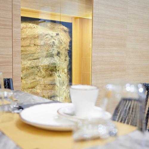 a table with a cup and a plate on it at The Mavili urban stay in Thessaloniki