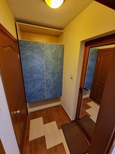 an empty room with a large glass door and a hallway at Kaloyanova House Bansko in Bansko