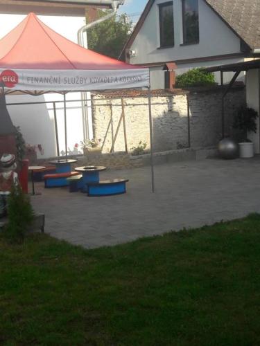 a patio with tables and a tent in a yard at Chata Milan in Hrabušice