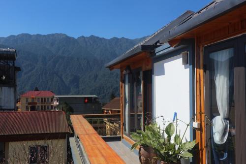 a balcony of a house with a view of the mountains at Mây Núi Homestay in Sa Pa