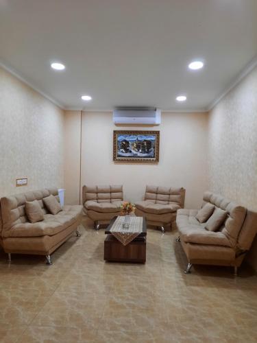 a large waiting room with couches and a table at Hotel LU-MA in Tbilisi City