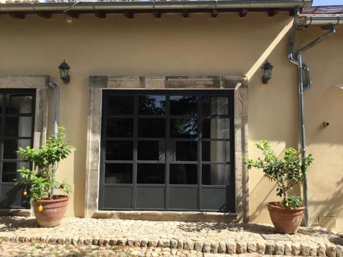 a garage door with two potted plants in front of it at Agriturismo Castello Santa Margherita in Cori