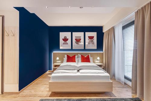 a bedroom with a bed and a dresser at Vonder Munich in Munich