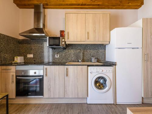 a kitchen with a white refrigerator and a washing machine at Apartment El Ventanico by Interhome in Olocau del Rey