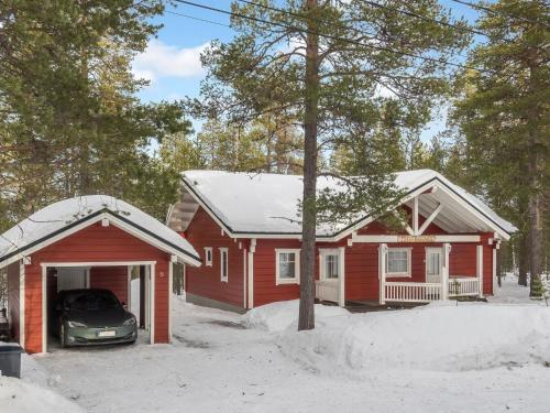 a red house with a car parked in front of it at Holiday Home Petsukantähti by Interhome in Sirkka