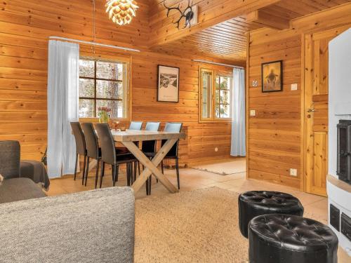 a dining room with a table and chairs at Holiday Home Villa hanhi by Interhome in Rovaniemi