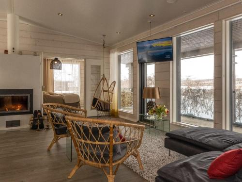 a living room with a couch and a fireplace at Holiday Home Haltinmalla by Interhome in Kilpisjärvi