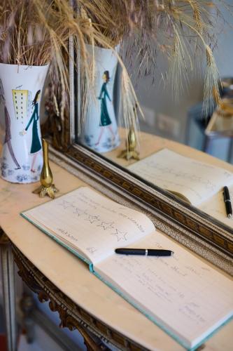 a desk with a mirror and a pen and a notebook at Villa Marengo Guest House in Spinetta Marengo