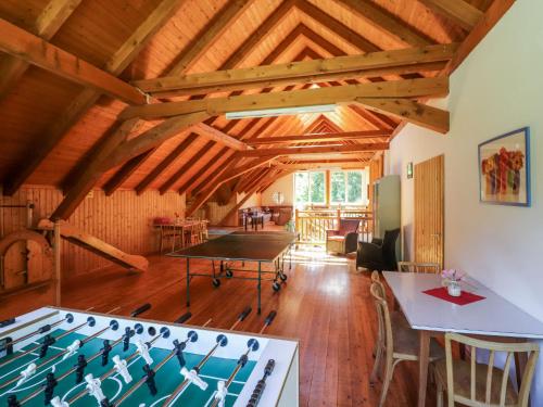 a room with a ping pong table in the middle at Holiday Home Wood Cube by Interhome in Sachsenburg