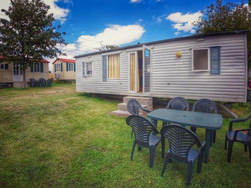 a picnic table and chairs in front of a caravan at Holiday Home Prima by Interhome in Prague